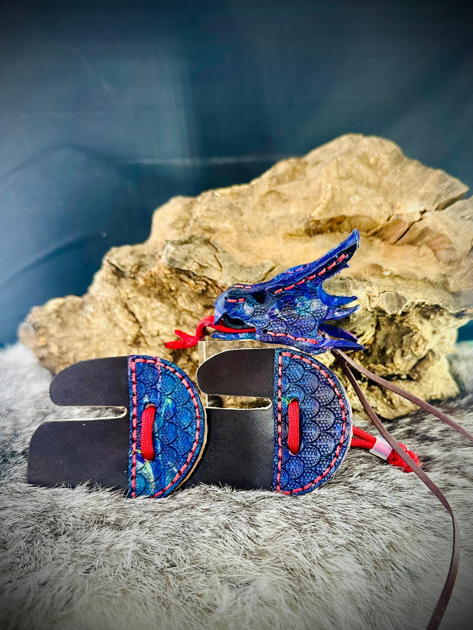 Blue dragon scale archery tabs with sculpted blue leather dragon head topper and red cord