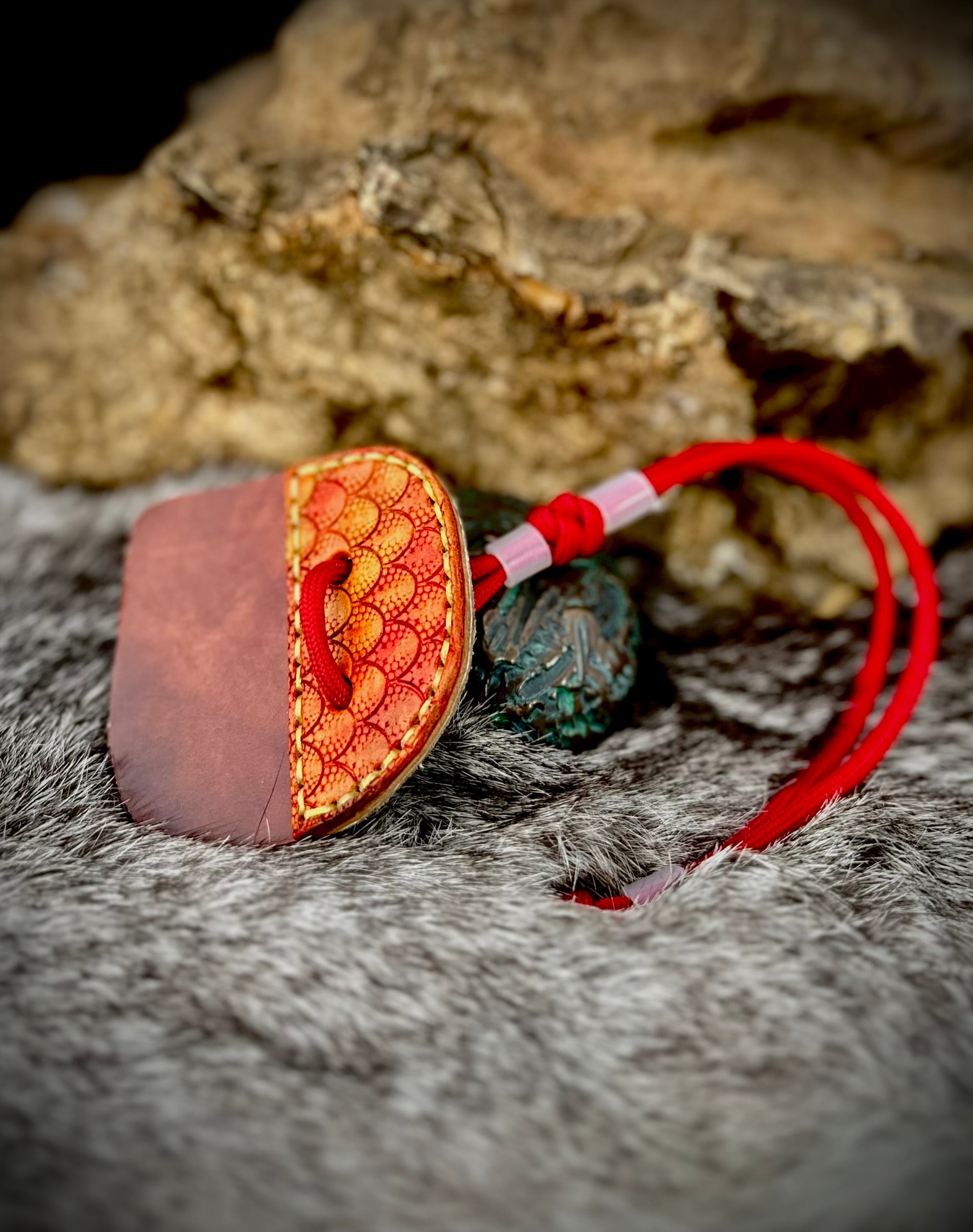 Orange dragon scale archery tab with jade dragon charm on red paracord